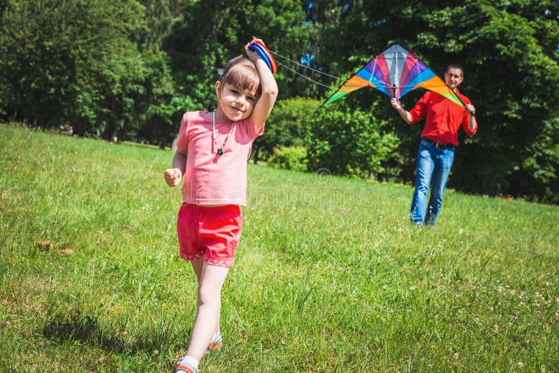 The girl and her father play with a kite. royalty free stock photo The girl and her father play with a kite. royalty free stock photo