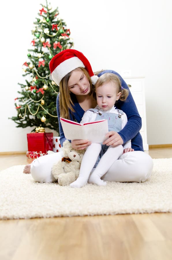 Girl and her mom reading book