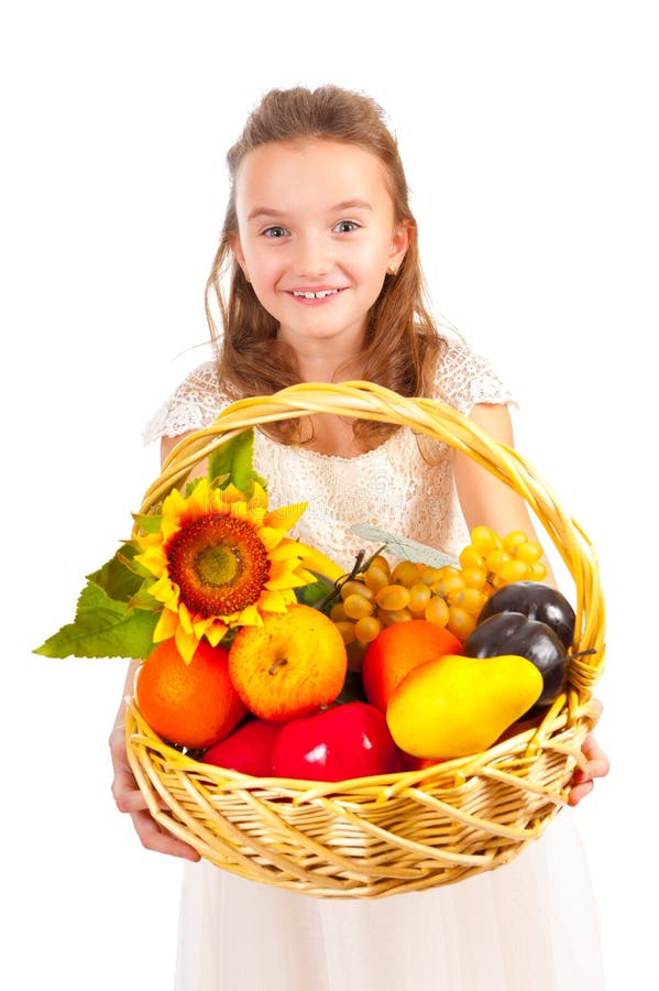 Girl holding basket full of fresh fruit