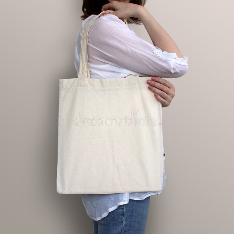 Girl is holding blank cotton eco bag, design mockup. Handmade shopping bag for girls.