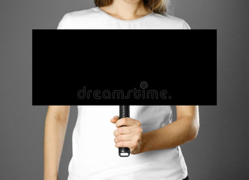 Girl holding a cardboard sign with a handle. Close up. Isolated background royalty free stock image Girl holding a cardboard sign with a handle. Close up. Isolated background royalty free stock image