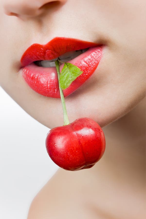 Girl holding a cherry