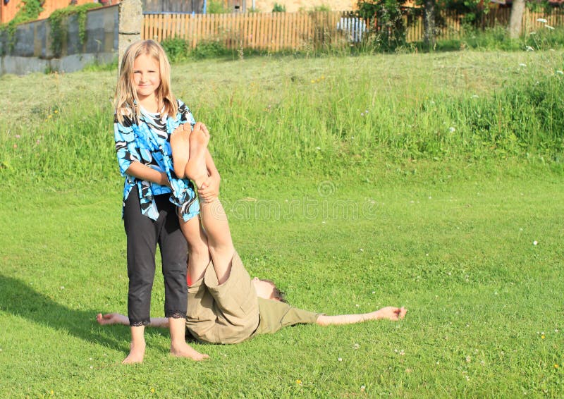 Girl holding feet of a boy