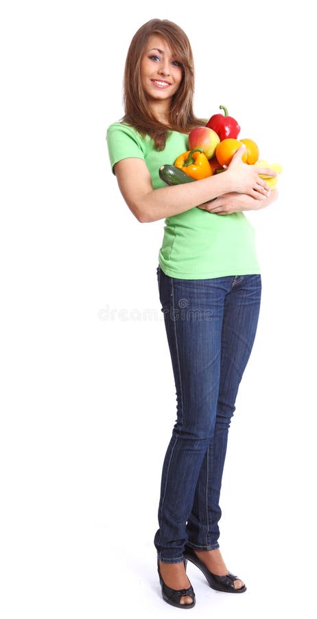 Girl holding in hands full of different fruits an