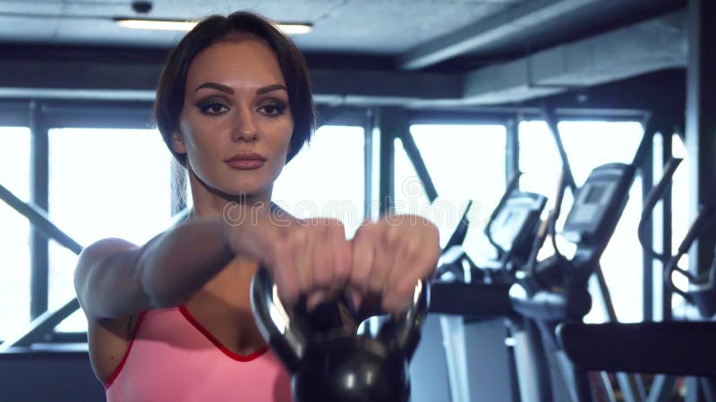 The sporty girl is doing exercises with heavy dumbbells royalty free stock images The sporty girl is doing exercises with heavy dumbbells royalty free stock images