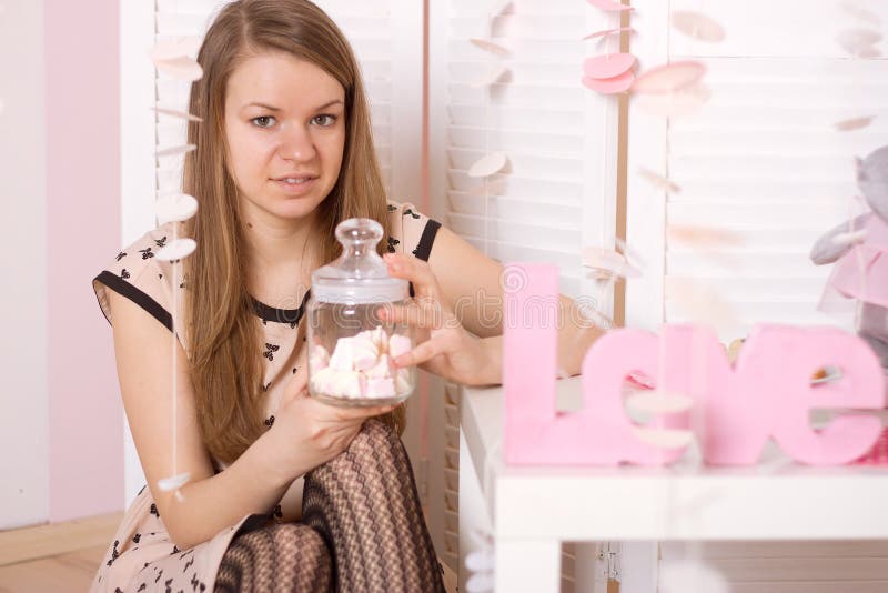 Girl holding a jar of marshmallow