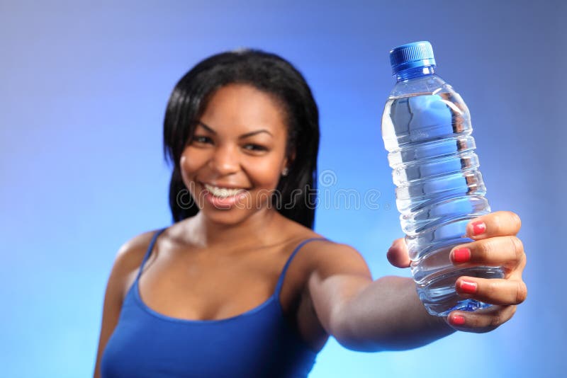 Girl holding out sharply focused bottled water