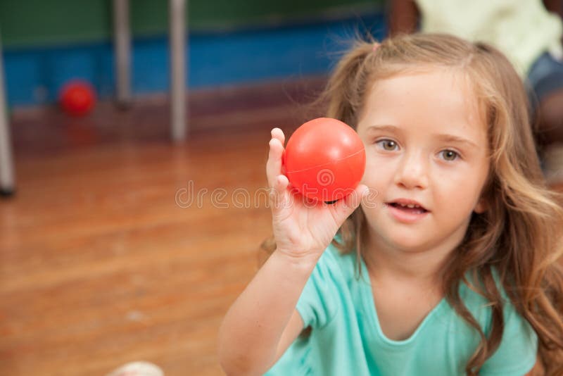 Girl Holding a Plastic Ball Stock Photo Image of pretty, elementary