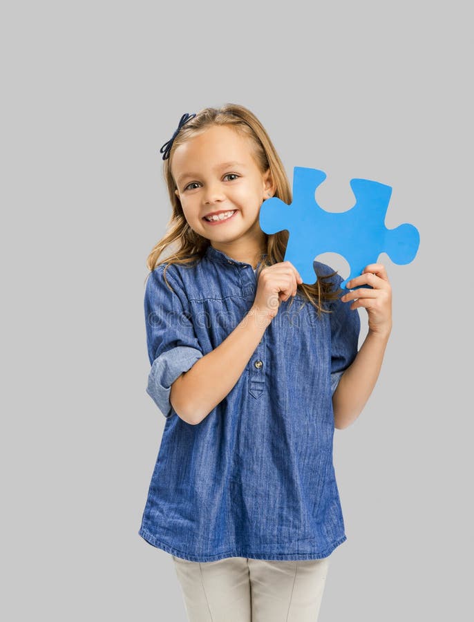 Girl holding a puzzle stock image. Image of cheerful 85352987