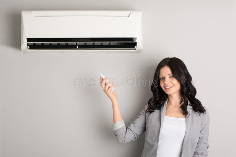 Girl holding a remote control air conditioner stock photography Girl holding a remote control air conditioner stock photography