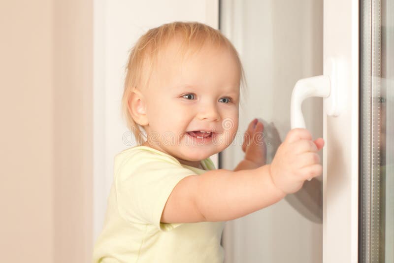 Girl holding window knob