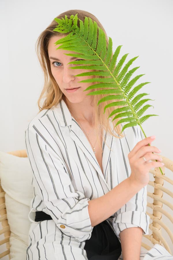 The Girl Holds a Leaf in Her Face. Portrait of a Woman Covering Her ...