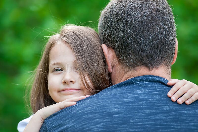 Girl hugging her father. Happy loving family. Dad and his daughter playing. Cute baby and daddy. Concept of Father day. Family hol