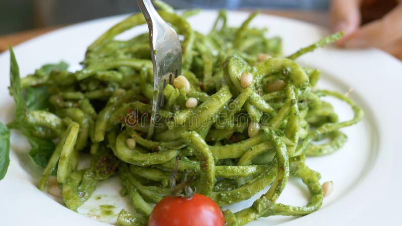 Girl inputs green fresh raw vegetable salad with peas close royalty free stock photos Girl inputs green fresh raw vegetable salad with peas close royalty free stock photos