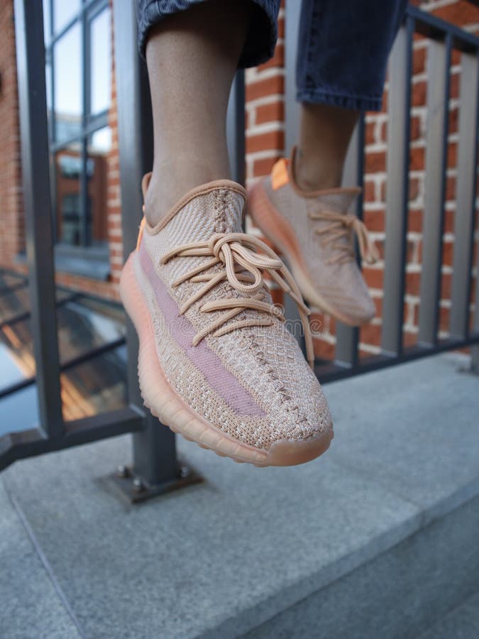 A Girl in Jeans and Cream Adidas Yeezy 