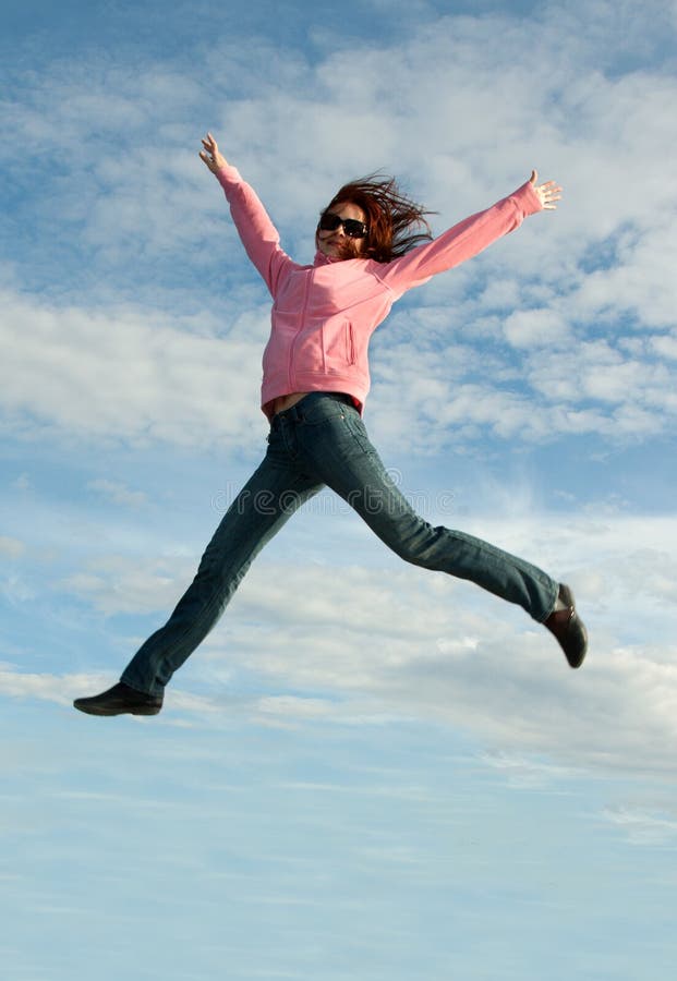 Girl in jump on background sky