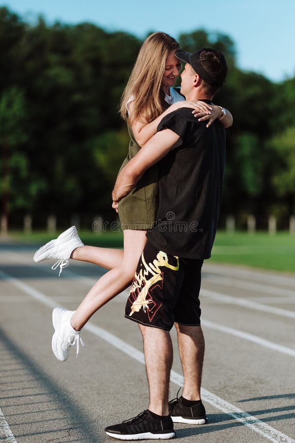 The Girl Jumped To the Guy in Her Arms Stock Photo - Image of happy ...