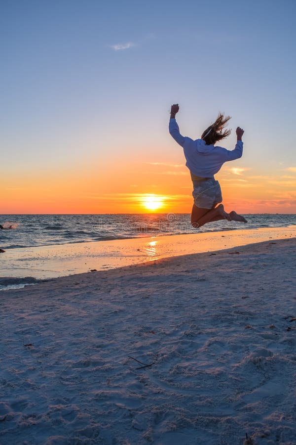 Girl Jumping On the Beach at Sunset