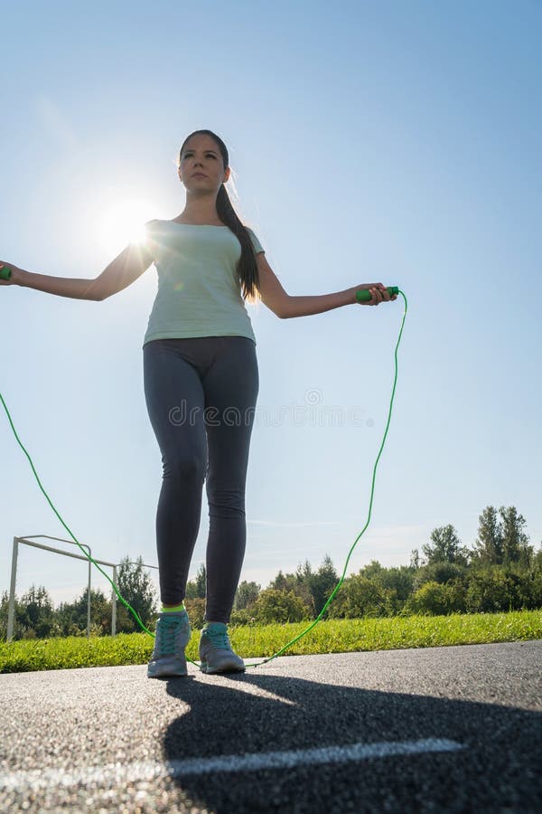 A Girl is Jumping Rope on a Treadmill of the Stadium Stock Photo