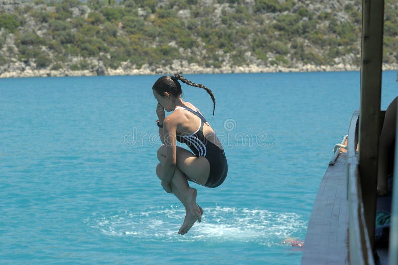 Girl jumping into the water