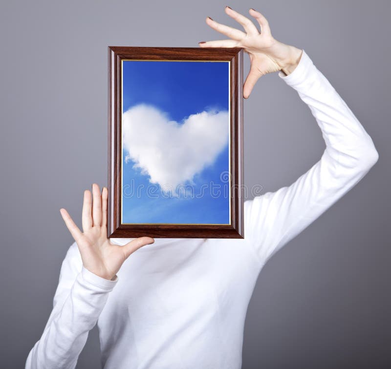Girl keep frame with cloud heart inside stock photo