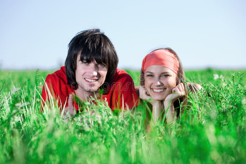 Girl in kerchief with boy on grass