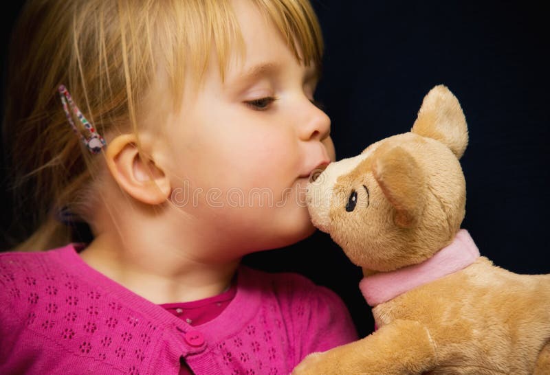 Girl kiss toy bear stock image Girl kiss toy bear stock image