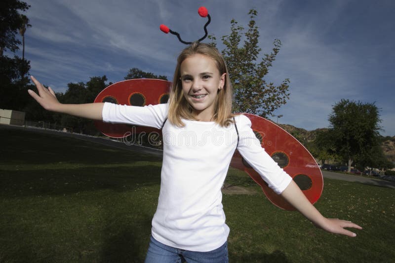 Girl In Ladybug Costume Outdoors