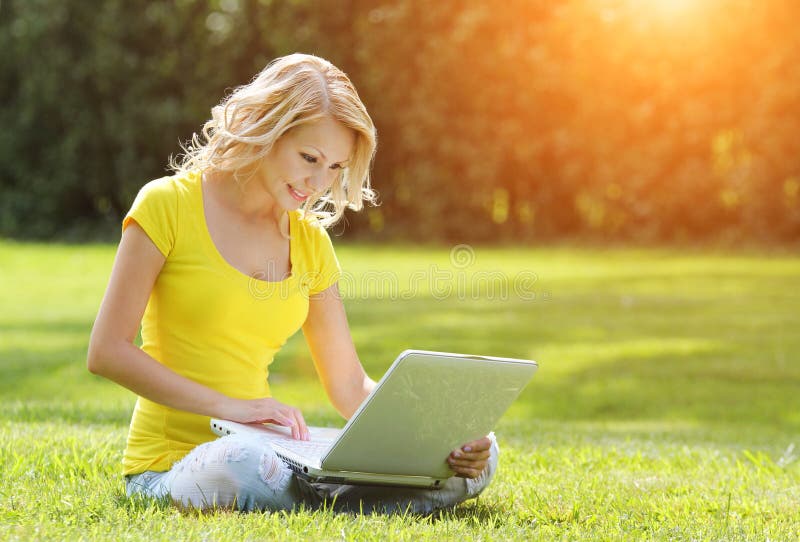 Girl with laptop. Blonde beautiful young woman with notebook