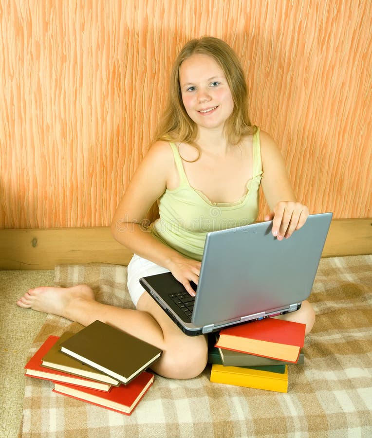 Girl with laptop and books