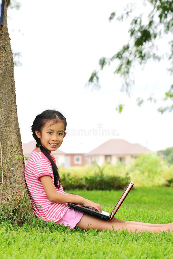 Girl with a laptop in the garden