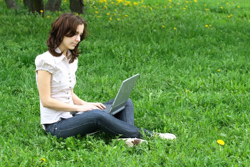 The girl with laptop on the nature