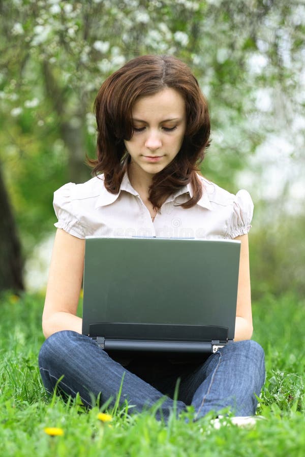 Girl with the laptop on the nature