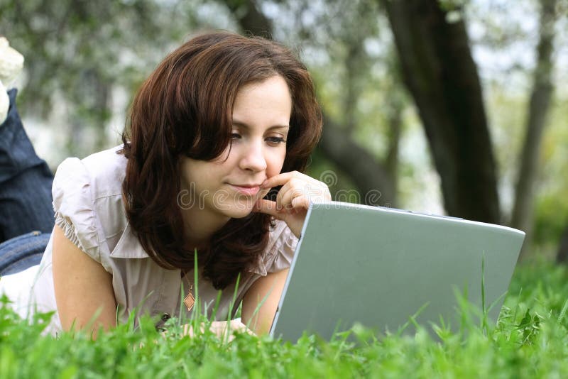 The girl with laptop on the nature