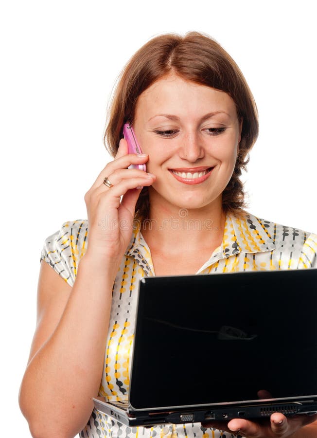 Girl with the laptop speaks by a mobile phone