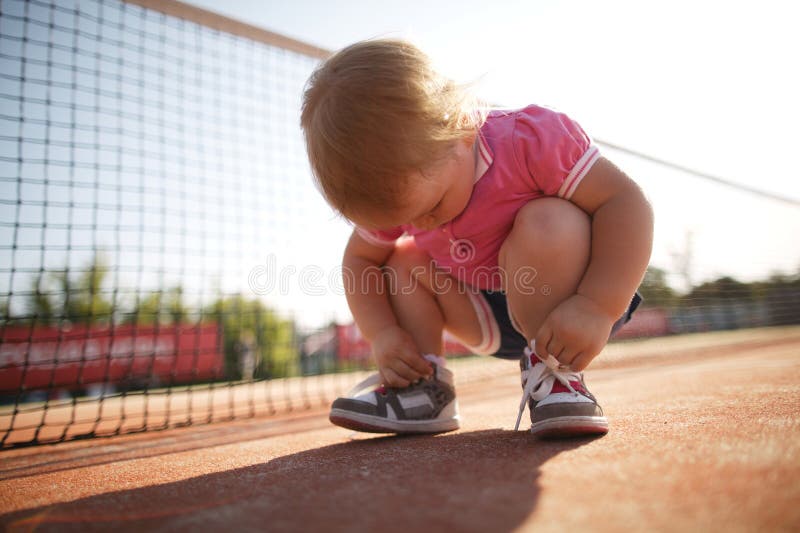 Girl learning to tie shoelaces