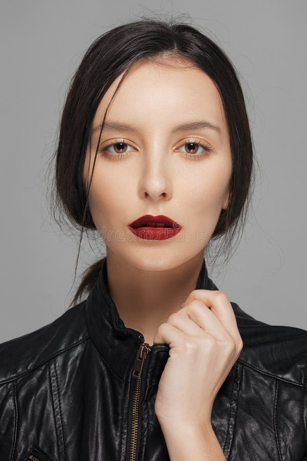 Girl in Leather Jacket Touching Collar. Red Mat Lips Stock Photo