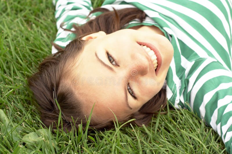 Girl lies on grass