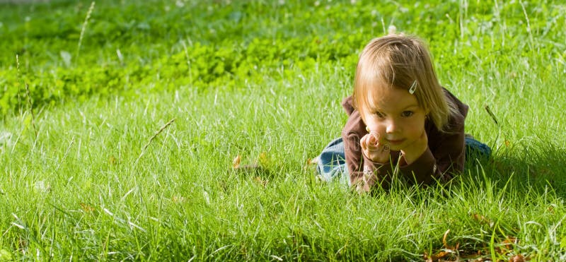 Girl lies on grass