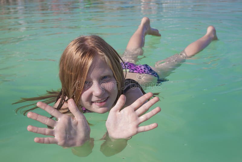 Girl lies on the water in the Dead Sea