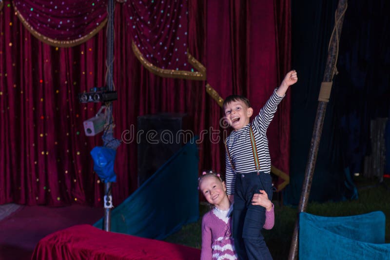 Girl Lifting Boy Up on Shoulders on Stage