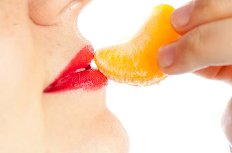 Girl lips eating tangerine mandarine