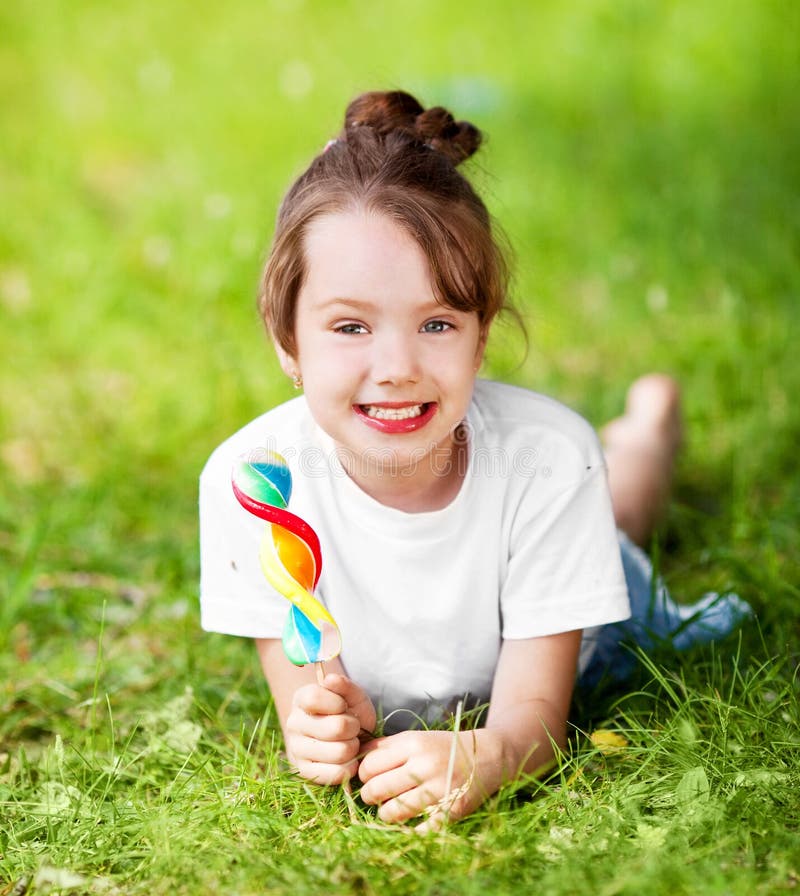 Cute Little Girl Eating Lollipop Grass Summertime Stock Photos - Free ...