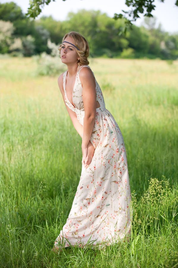 Girl in a a long dress on nature