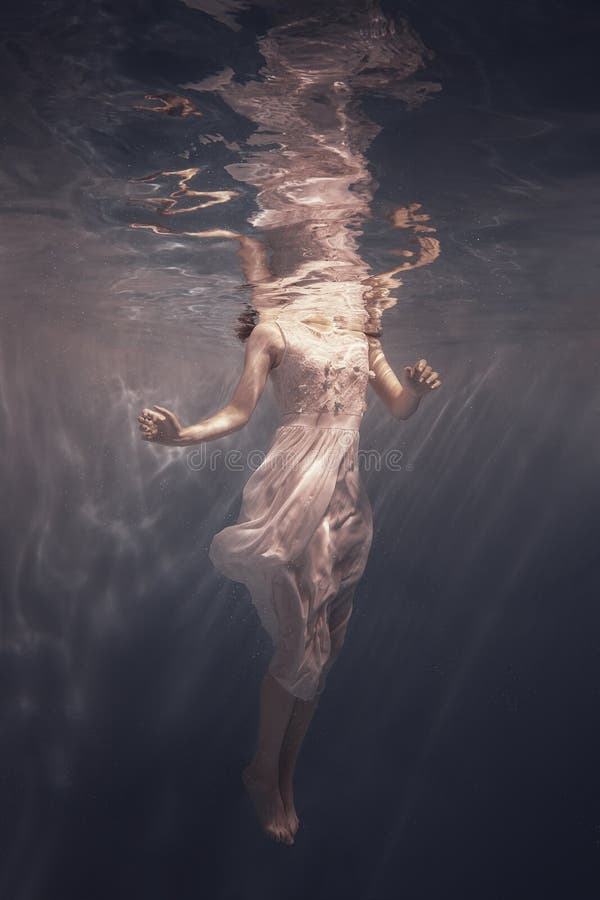 Girl with long hair swims underwater