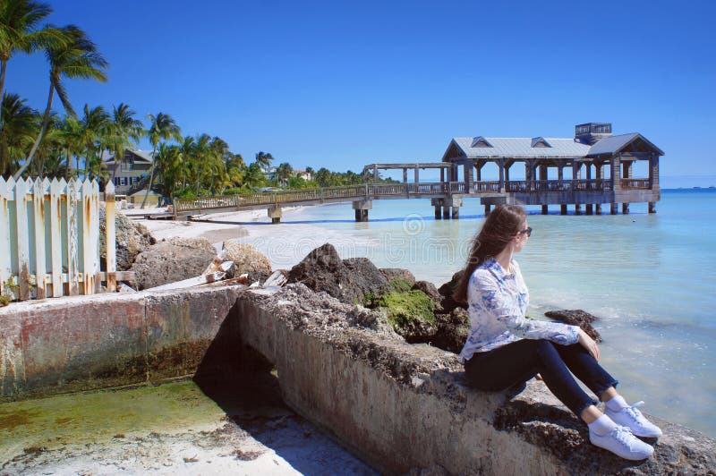 Girl look at the Atlantic Ocean near old Key West pier