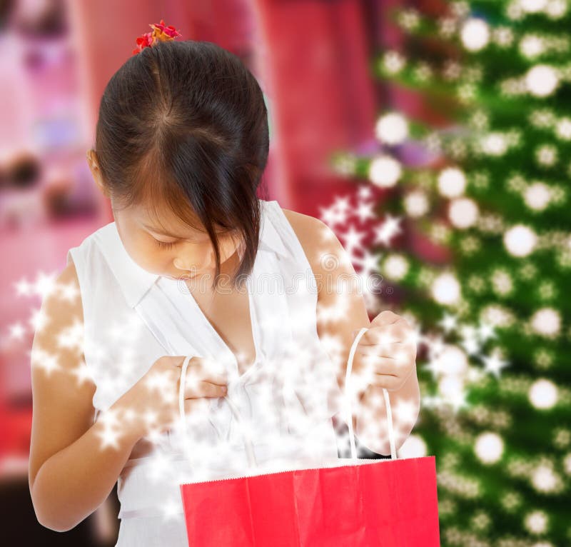 Girl Looking At Her Sparkling Christmas Gift