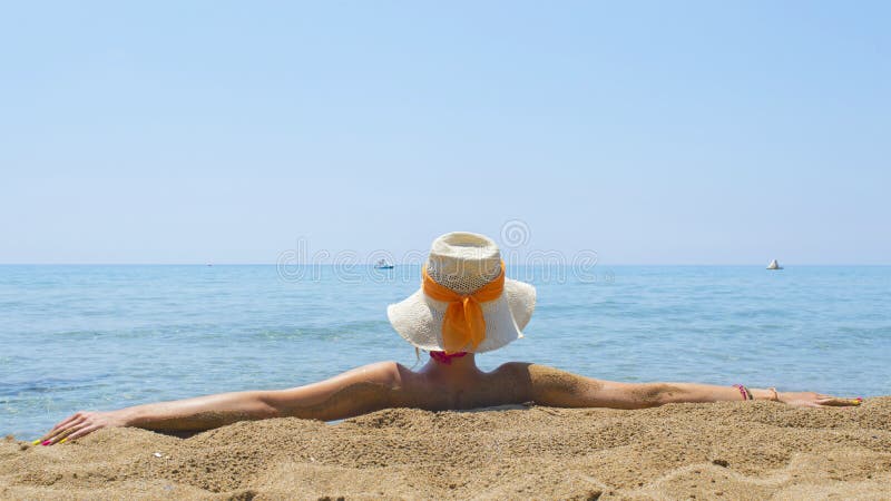 Girl looking at sea while sitting on the beach royalty free stock images Girl looking at sea while sitting on the beach royalty free stock images