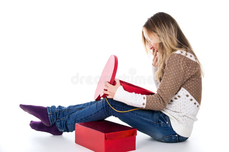 Girl looks at gifts, red boxes