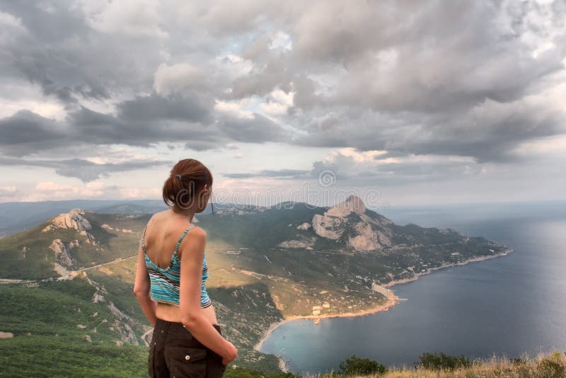 Girl looks at majestic landscape